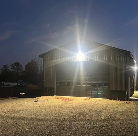 A barn illuminated at night in a rural setting